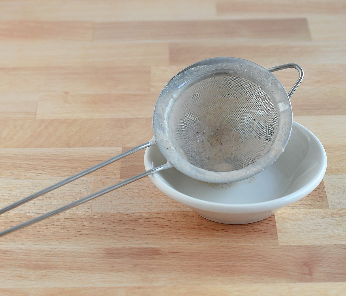 Fine mesh bar strainer after straining the pecan milk.