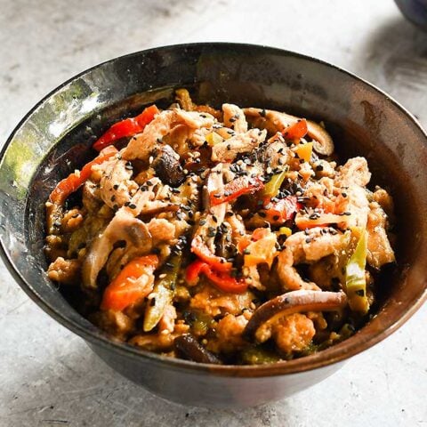 Date Sweetened Teriyaki Soy Curls in a brown ceramic bowl with 2 rice bowls