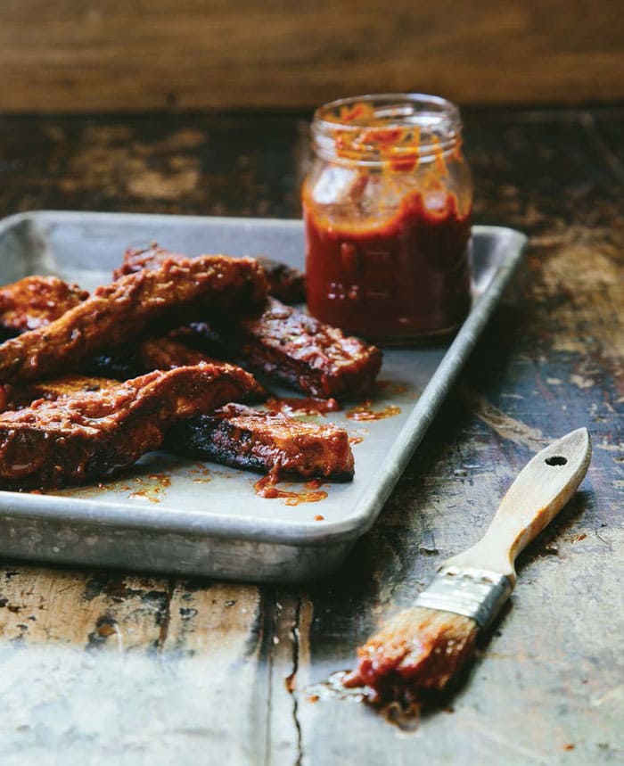 Easy Homemade Seitan Ribs on a baking sheet with jar of bbq sauce