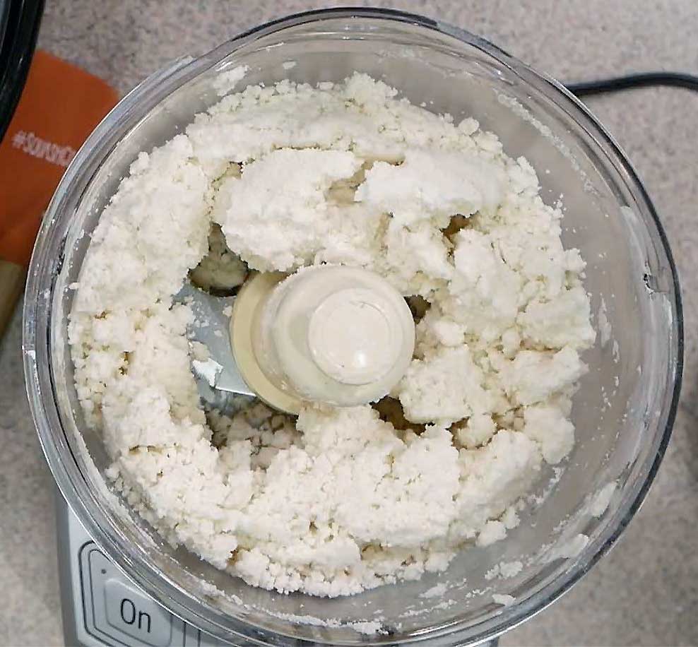 Gluten-free pie crust ingredients in a food processor to make it quick and easy.
