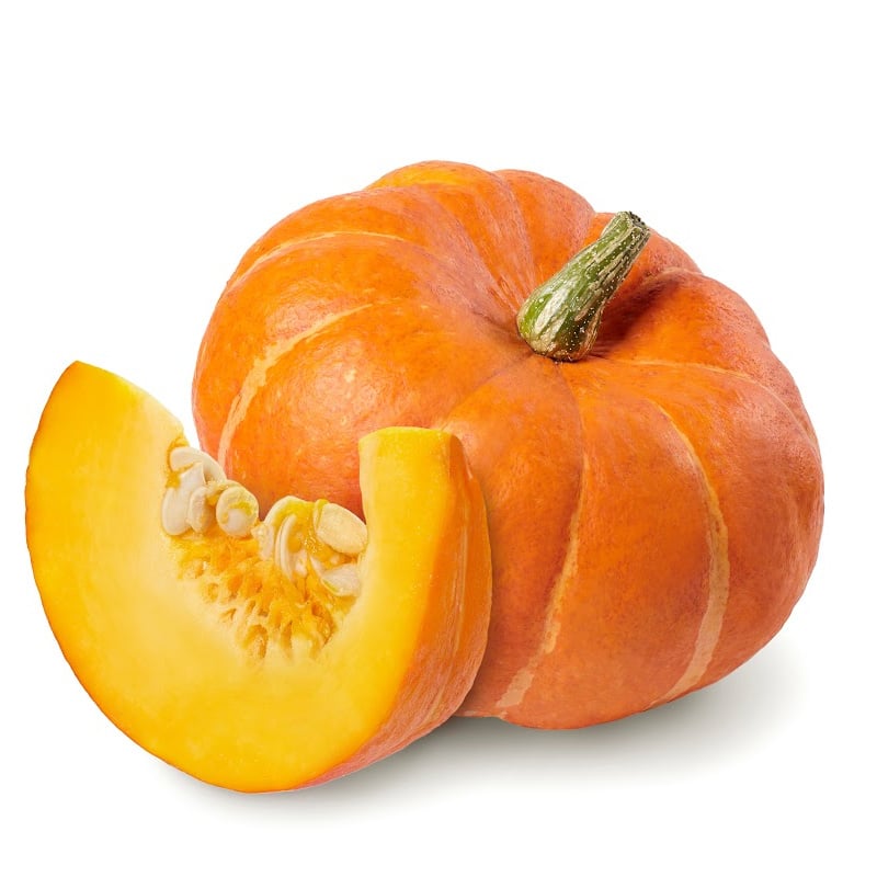 Fresh pumpkin cut in a quarter beside a whole one