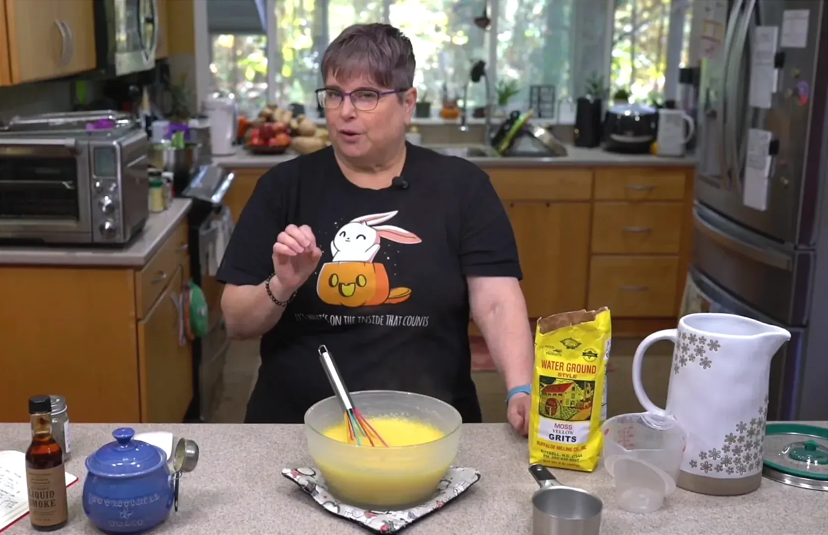 Whisking the cooked grits.