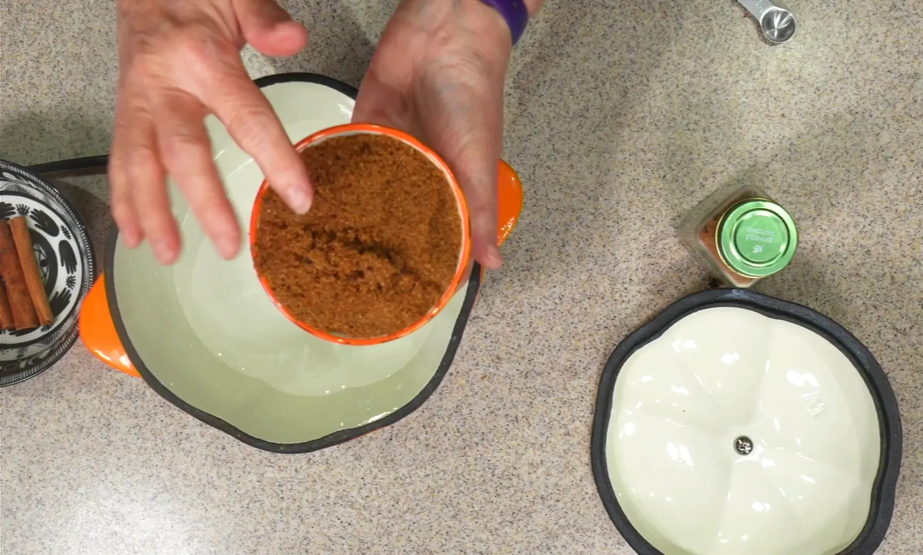 Adding packed brown sugar to the slow cooker.